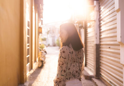 Side view of woman standing outdoors