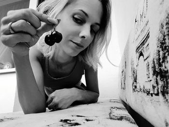 Close-up of woman having cherries at table