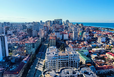 High angle view of city buildings against clear sky