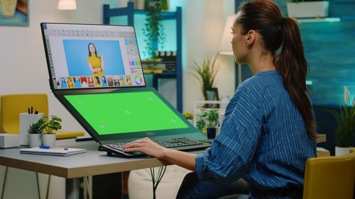 Graphic designer working on laptop in office