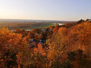 Scenic view of townscape against clear sky during autumn