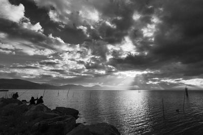 Scenic view of sea against cloudy sky