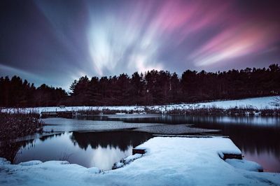 Scenic view of frozen lake against sky at night