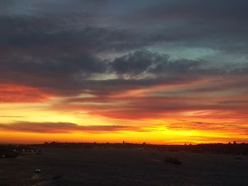 Scenic view of dramatic sky over sea during sunset