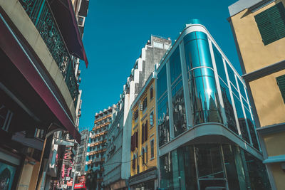 Low angle view of buildings against blue sky