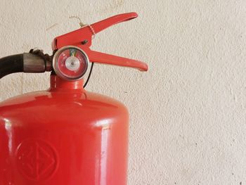 Close-up of telephone booth against wall