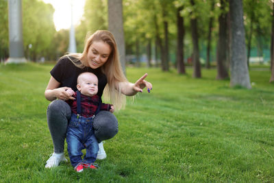 Mother playing with cute son in park