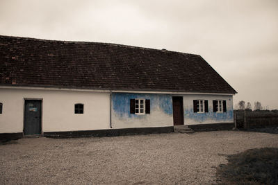 Exterior of house by building against sky