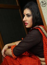 Young woman looking away while sitting at home