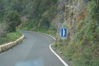 Road sign by trees