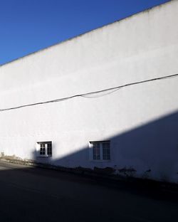 Low angle view of building against clear blue sky