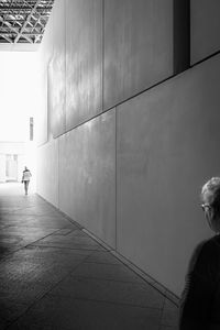 Rear view of man walking on wall