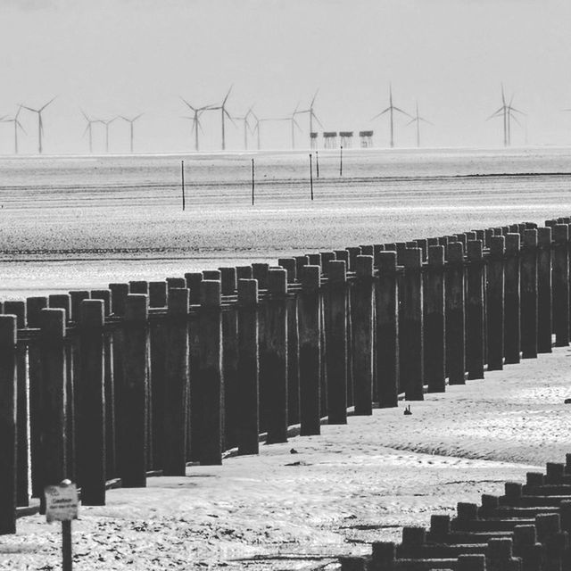 ROW OF TRADITIONAL WINDMILL ON BEACH