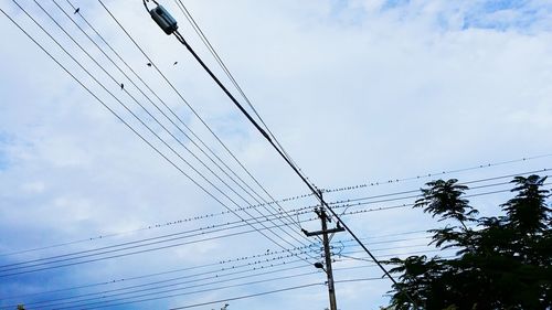 Low angle view of electricity pylon against sky