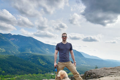 Portrait of young man against mountains