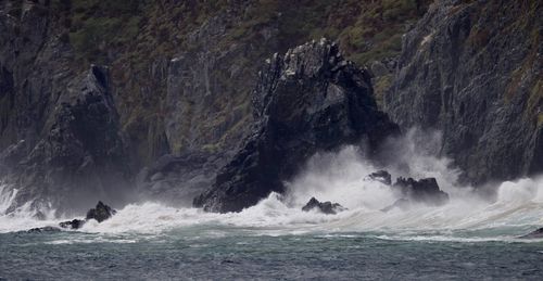 Scenic view of sea against rocks