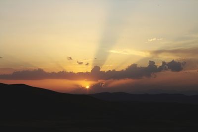 Scenic view of silhouette mountains against sky during sunset