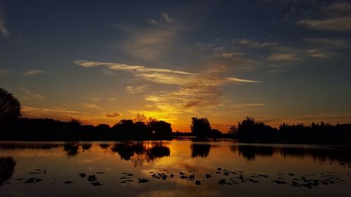 Scenic view of lake at sunset