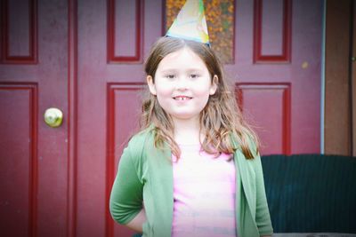 Portrait of smiling girl wearing party hat