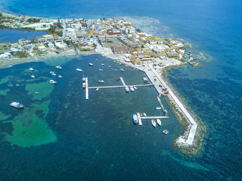 High angle view of airplane flying over sea against sky