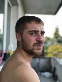 Close-up portrait of shirtless man