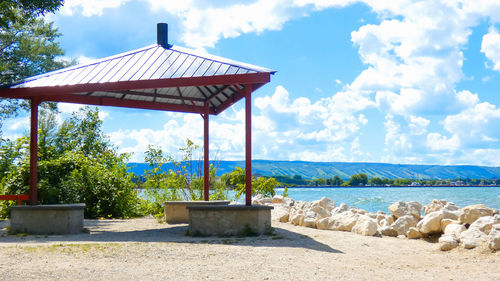 Gazebo by sea against sky