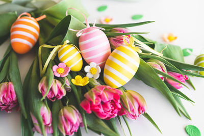 Happy easter. stylish dyed easter eggs with spring flowers