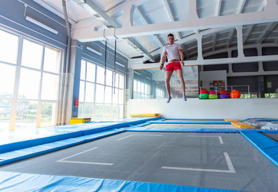 Man jumping in swimming pool