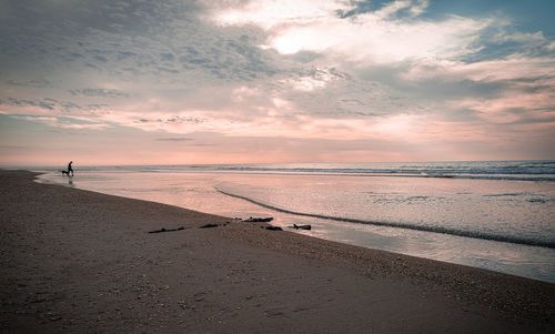 Scenic view of beach against sky during sunset