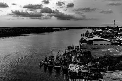 High angle view of buildings by sea against sky