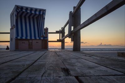 Pier on sea at sunset