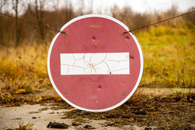 Close-up of stop sign on field