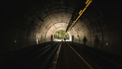 Railroad tracks in illuminated tunnel