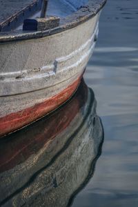 Close-up of boat moored in lake