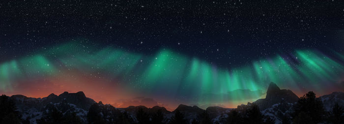 Scenic view of snowcapped mountains against sky at night