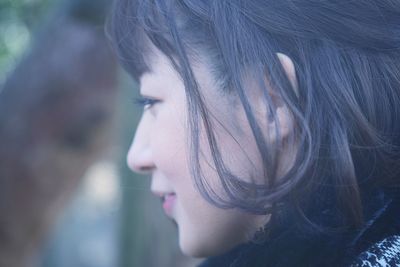 Close-up portrait of woman looking away outdoors