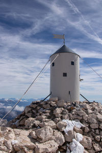 Low angle view of building by sea against sky