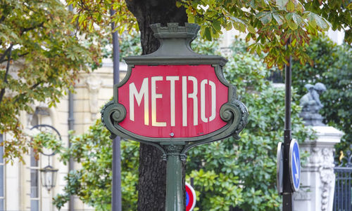 Red road sign on street in city