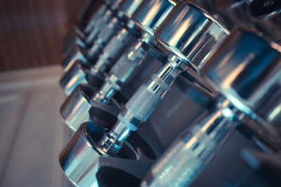 Close-up of dumbbells on rack in gym