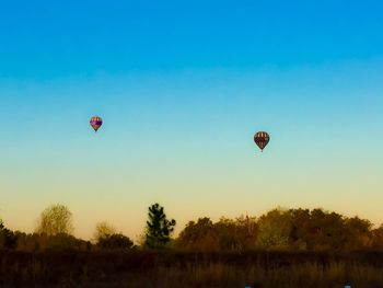 Hot air balloon flying over landscape