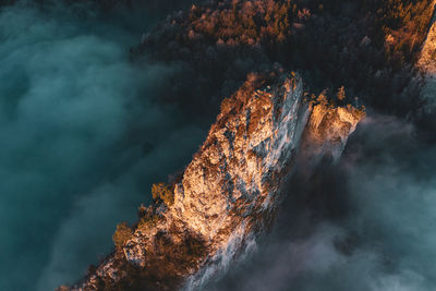 High angle view of mountain ridge rising above the clouds, hallein, austria.