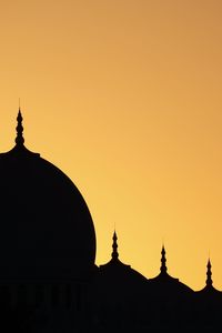 Silhouette temple against sky during sunset