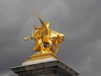 Low angle view of statue against sky in city