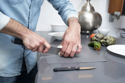 Midsection of man preparing food on table