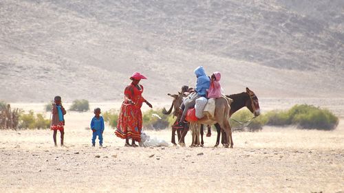 Rear view of people enjoying on land