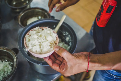 Midsection of man preparing food in kitchen