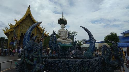 Statue against temple building against sky