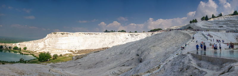 Panoramic view of people on mountain against sky