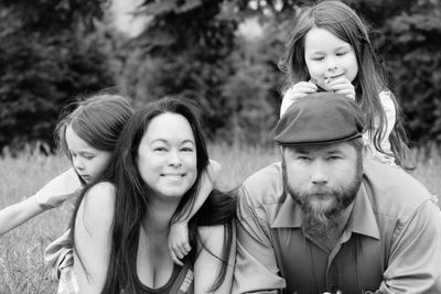 Portrait of parents with daughters on field