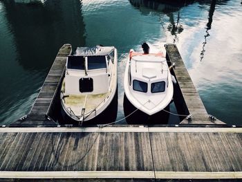 High angle view of small yachts moored at pier